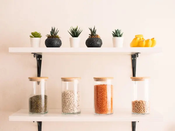Glass jars of packaged pantry goods on a clean shelf
